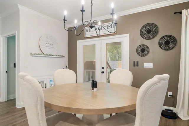 a bedroom with a bed a ceiling fan and a flat tv screen