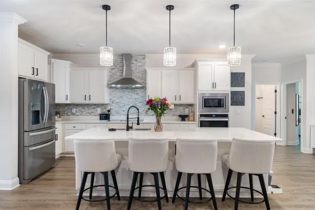 a spacious bathroom with double vanity and mirrors