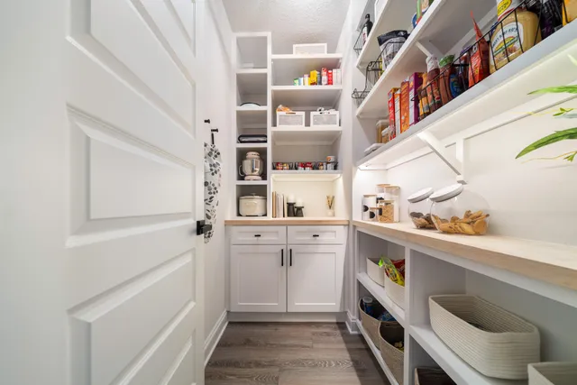 a bedroom with furniture and a wooden floor