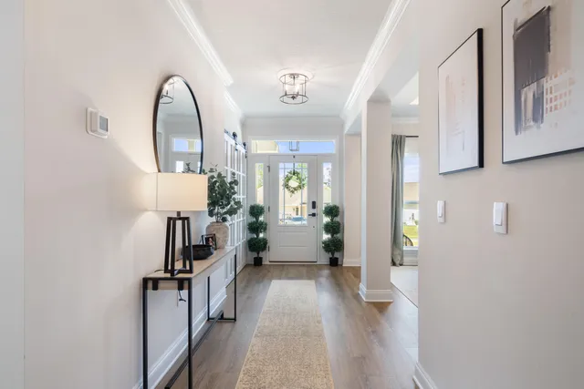 a view of a hallway to a livingroom with furniture