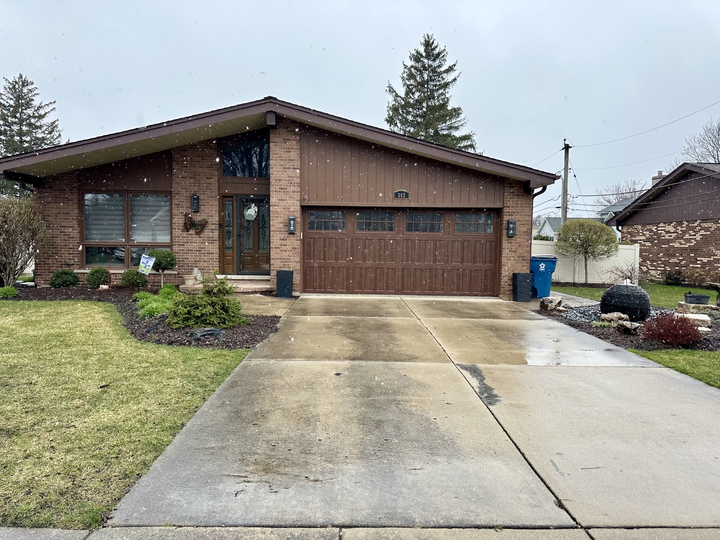302 North Westgate Road Mount Prospect, IL 60056 - Photo 1 of 26 a front view of a house with a yard and garage
