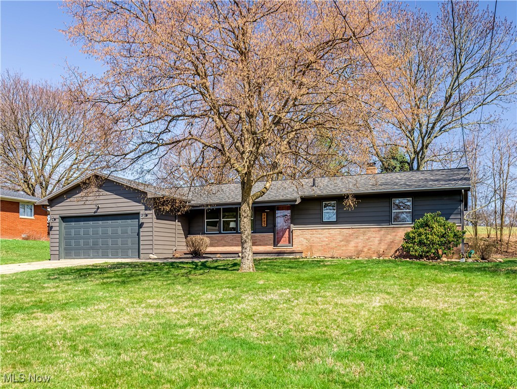 3995 Cottage Grove Road Uniontown, OH 44685 - Photo 1 of 29 Ranch-style home with driveway, an attached garage, brick siding, and a front yard