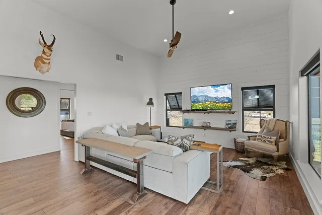 a dining room with furniture and wooden floor
