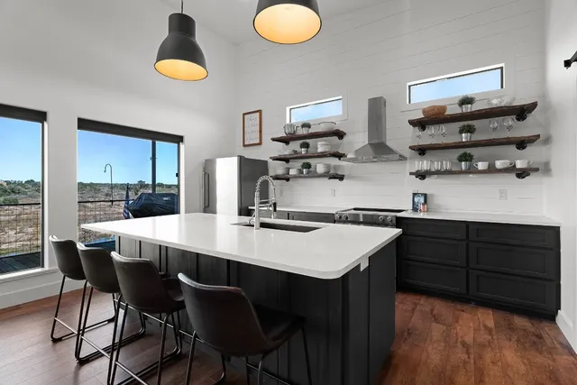 a kitchen with a sink and living room