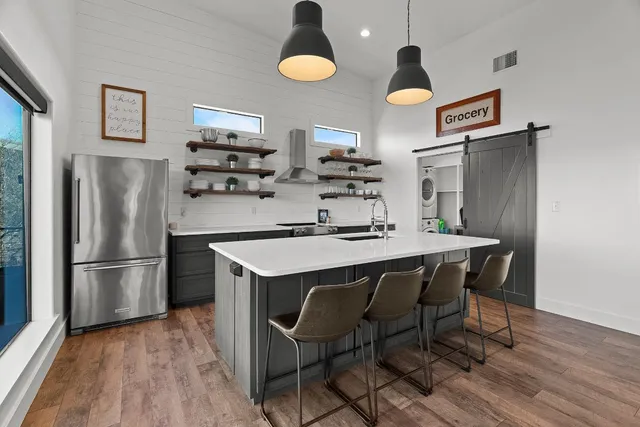 a view of a hallway with wooden floor and staircase