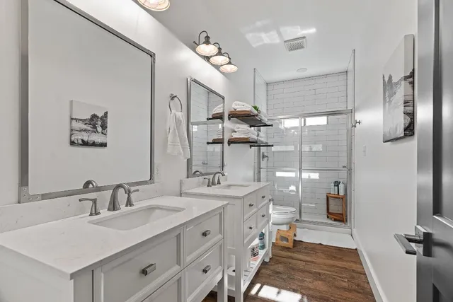 a close view of walk in closet with clothes and shoes