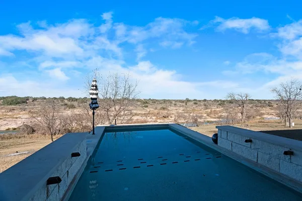 a view of swimming pool with seating space