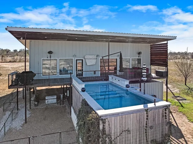 a view of a yard with wooden fence