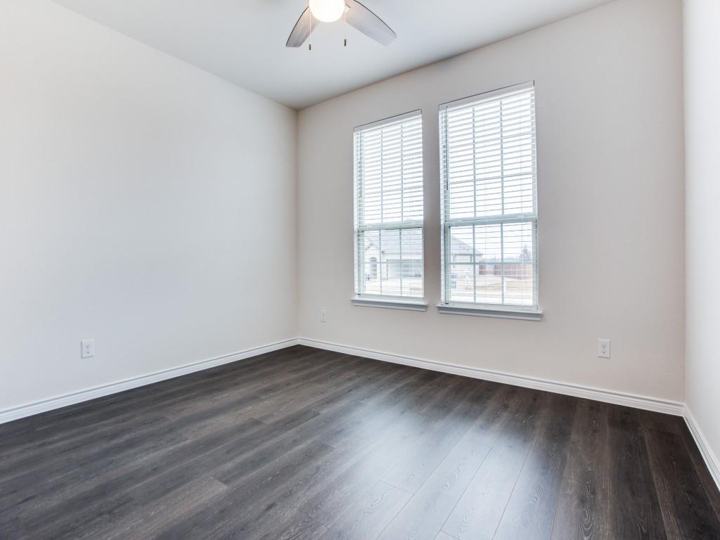 123 Lakeview Circle Pilot Point, TX 76258 - Photo 32 of 39 an empty room with wooden floor and windows