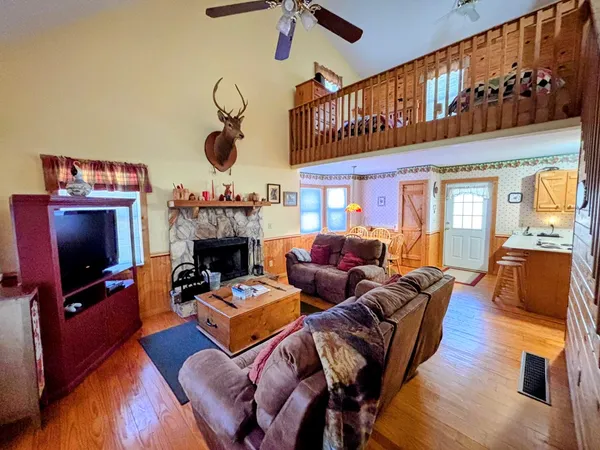 a living room with furniture a flat screen tv and a fireplace