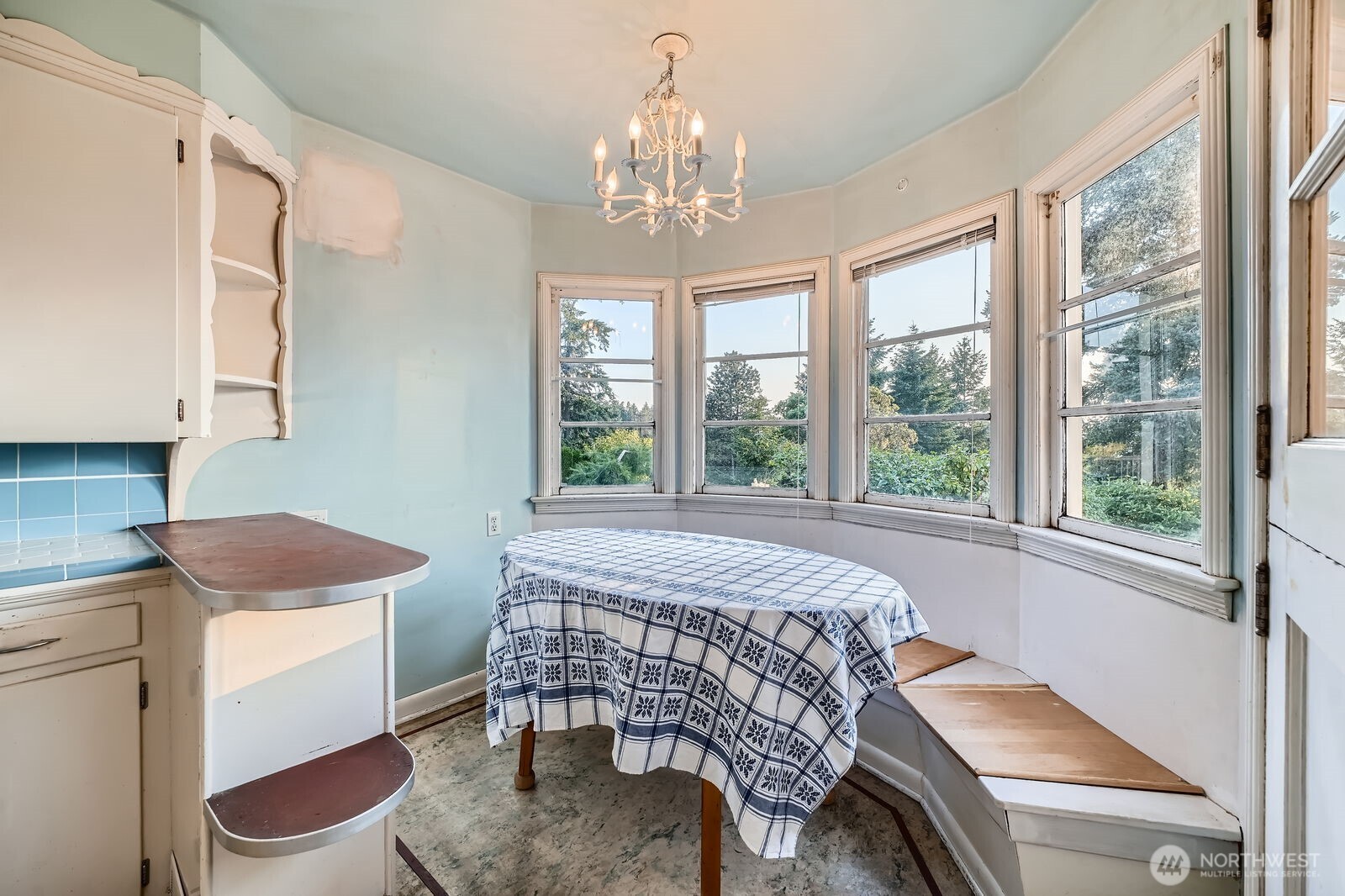 3041 52nd Avenue Southwest Seattle, WA 98116 - Photo 11 of 31 a bedroom with a bed and a chandelier