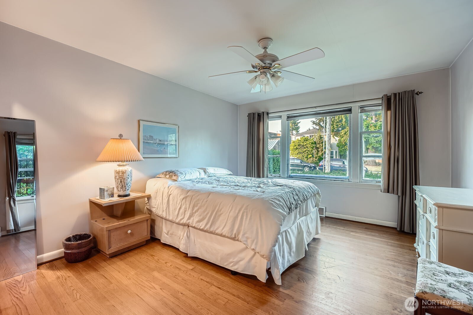 3041 52nd Avenue Southwest Seattle, WA 98116 - Photo 12 of 31 a bedroom with a bed and wooden floor
