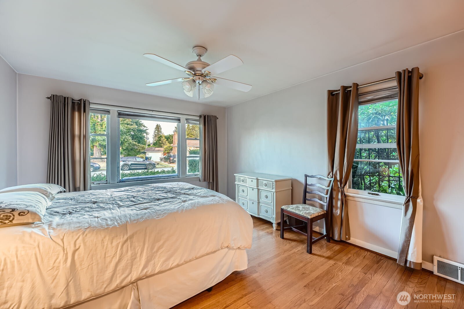 3041 52nd Avenue Southwest Seattle, WA 98116 - Photo 14 of 31 a bedroom with a bed a chair and a window