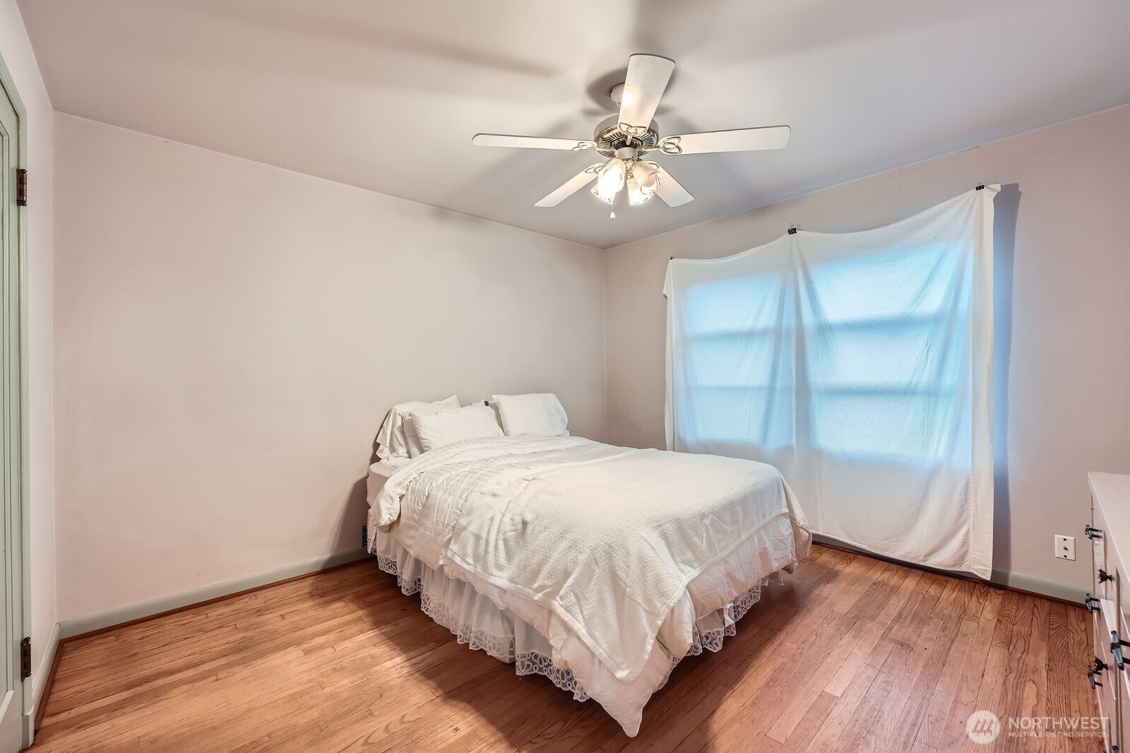 3041 52nd Avenue Southwest Seattle, WA 98116 - Photo 17 of 31 a bedroom with a bed and a window