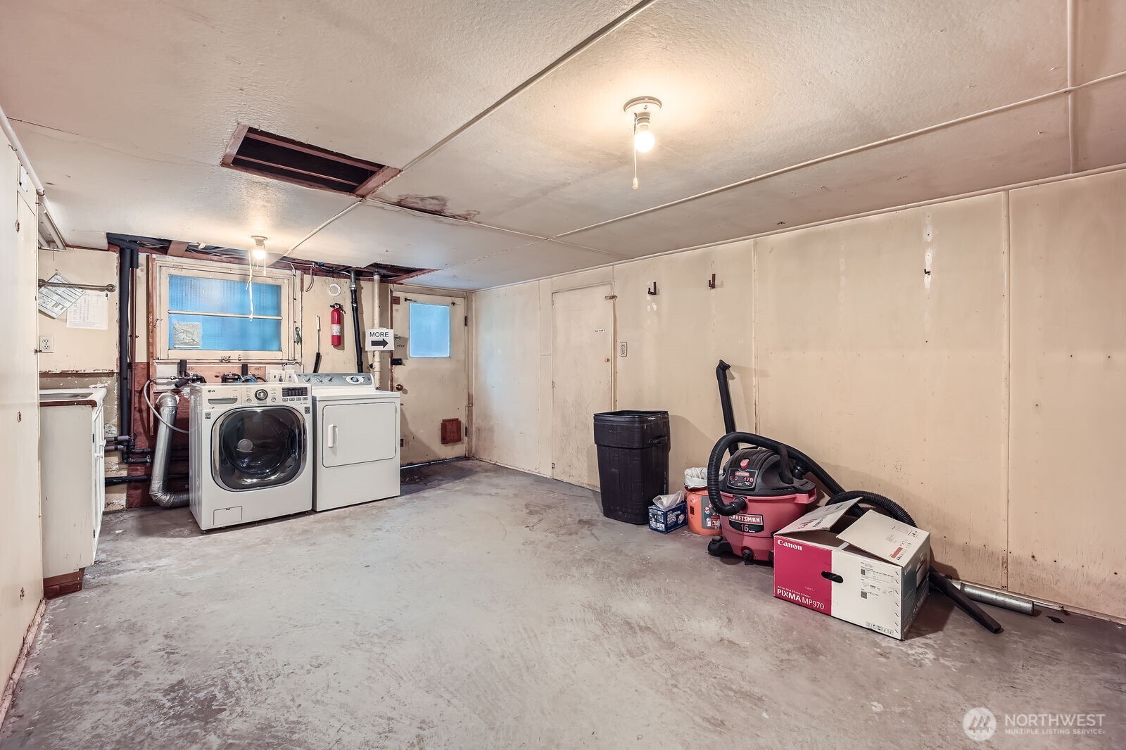 3041 52nd Avenue Southwest Seattle, WA 98116 - Photo 23 of 31 a utility room with a bed and furniture