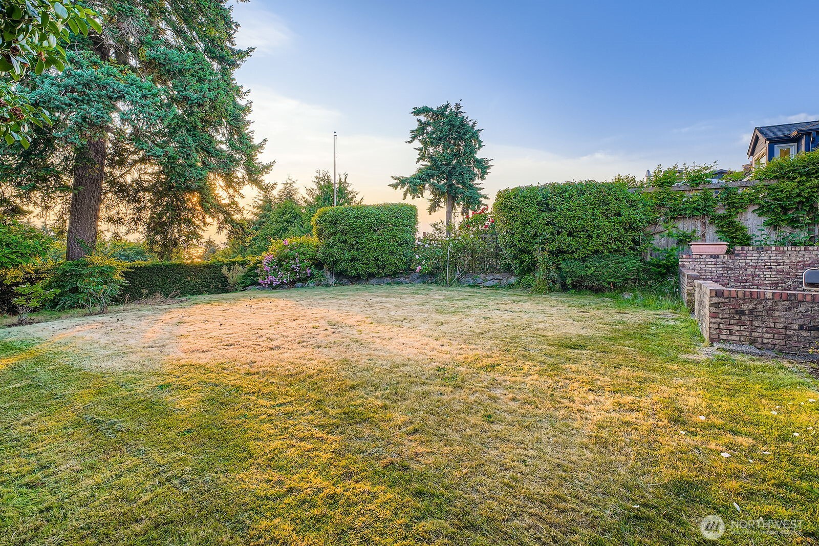 3041 52nd Avenue Southwest Seattle, WA 98116 - Photo 26 of 31 a view of a yard with a house in the background