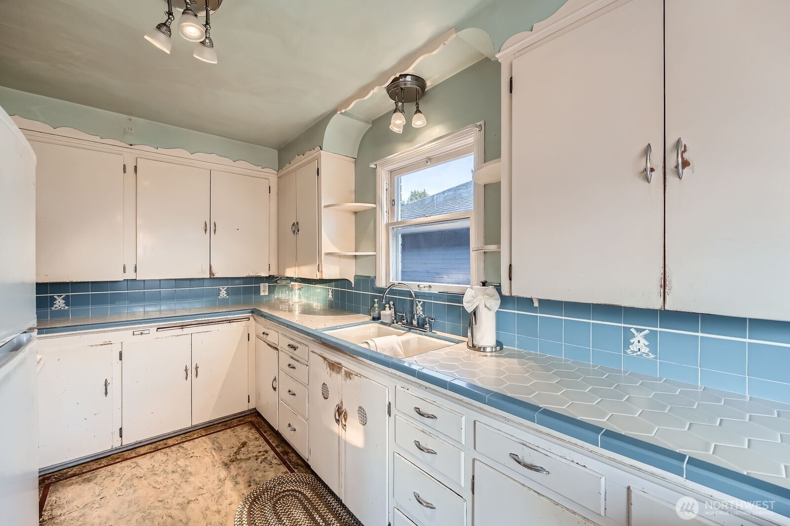 3041 52nd Avenue Southwest Seattle, WA 98116 - Photo 8 of 31 a bathroom with a sink and a mirror
