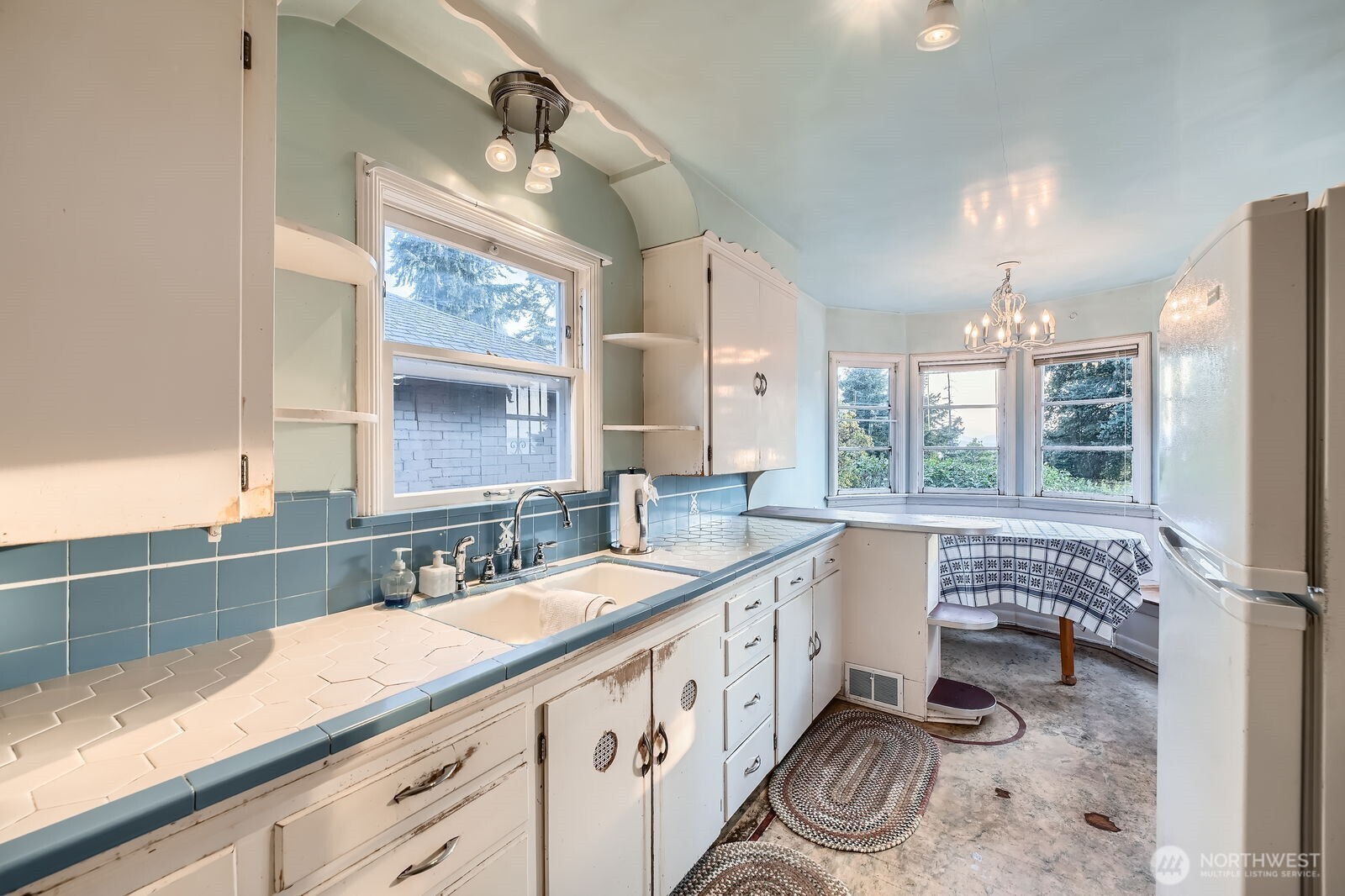 3041 52nd Avenue Southwest Seattle, WA 98116 - Photo 9 of 31 a bathroom with a double vanity sink a mirror and a bathtub