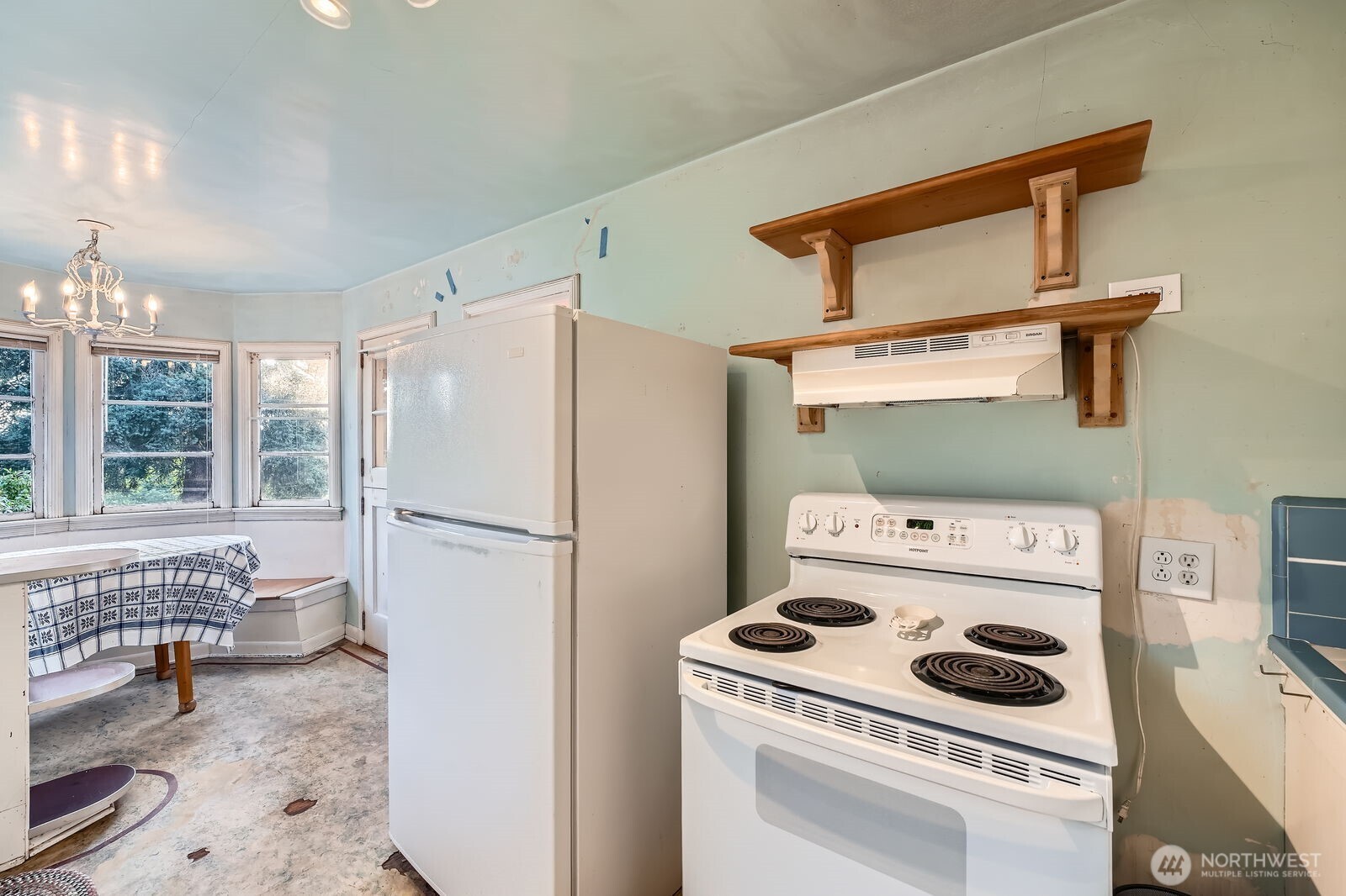3041 52nd Avenue Southwest Seattle, WA 98116 - Photo 10 of 31 a white refrigerator freezer and a stove sitting inside of a kitchen