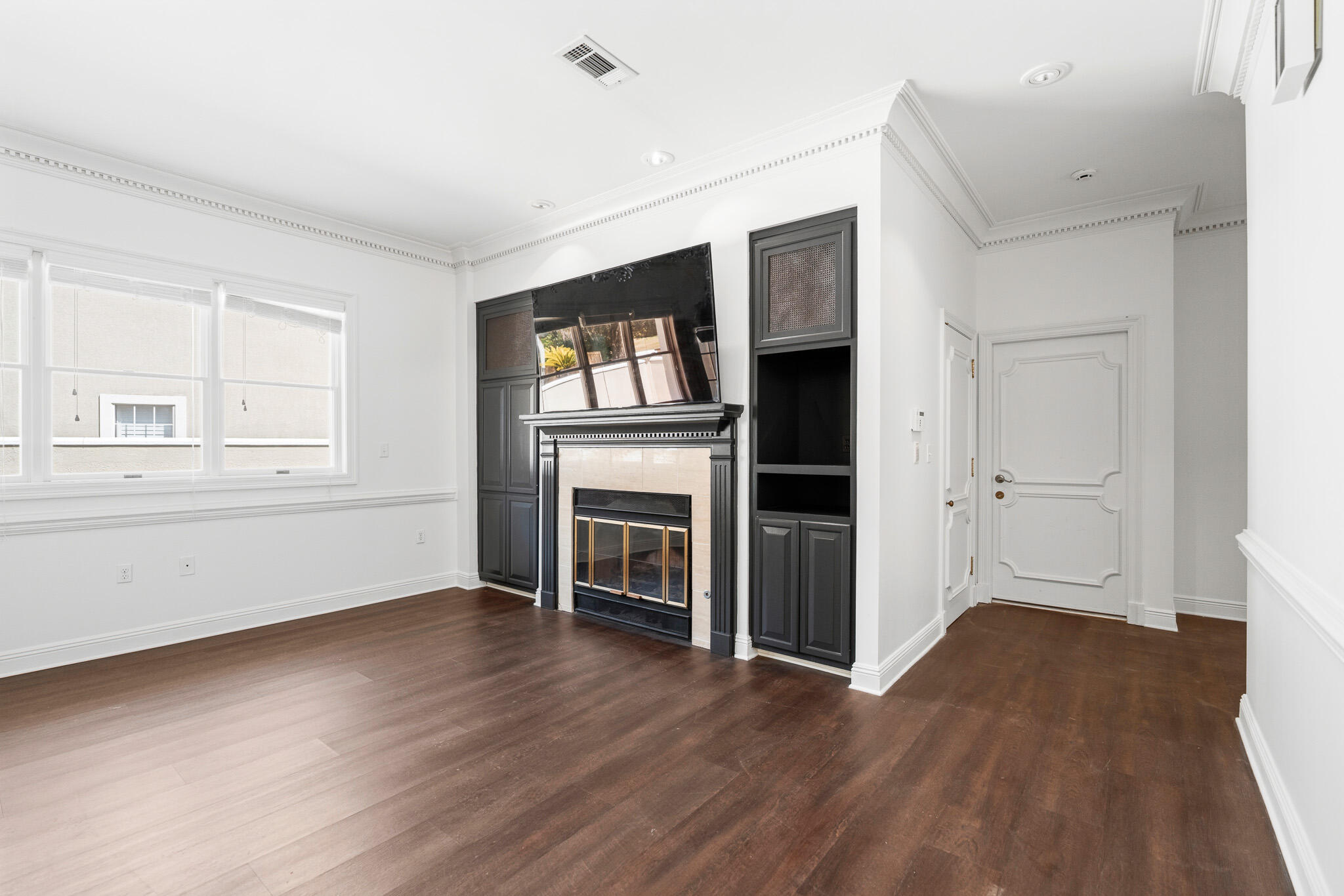 8 Weekewachee Circle Destin, FL 32541 - Photo 12 of 55 an empty room with wooden floor fireplace and windows