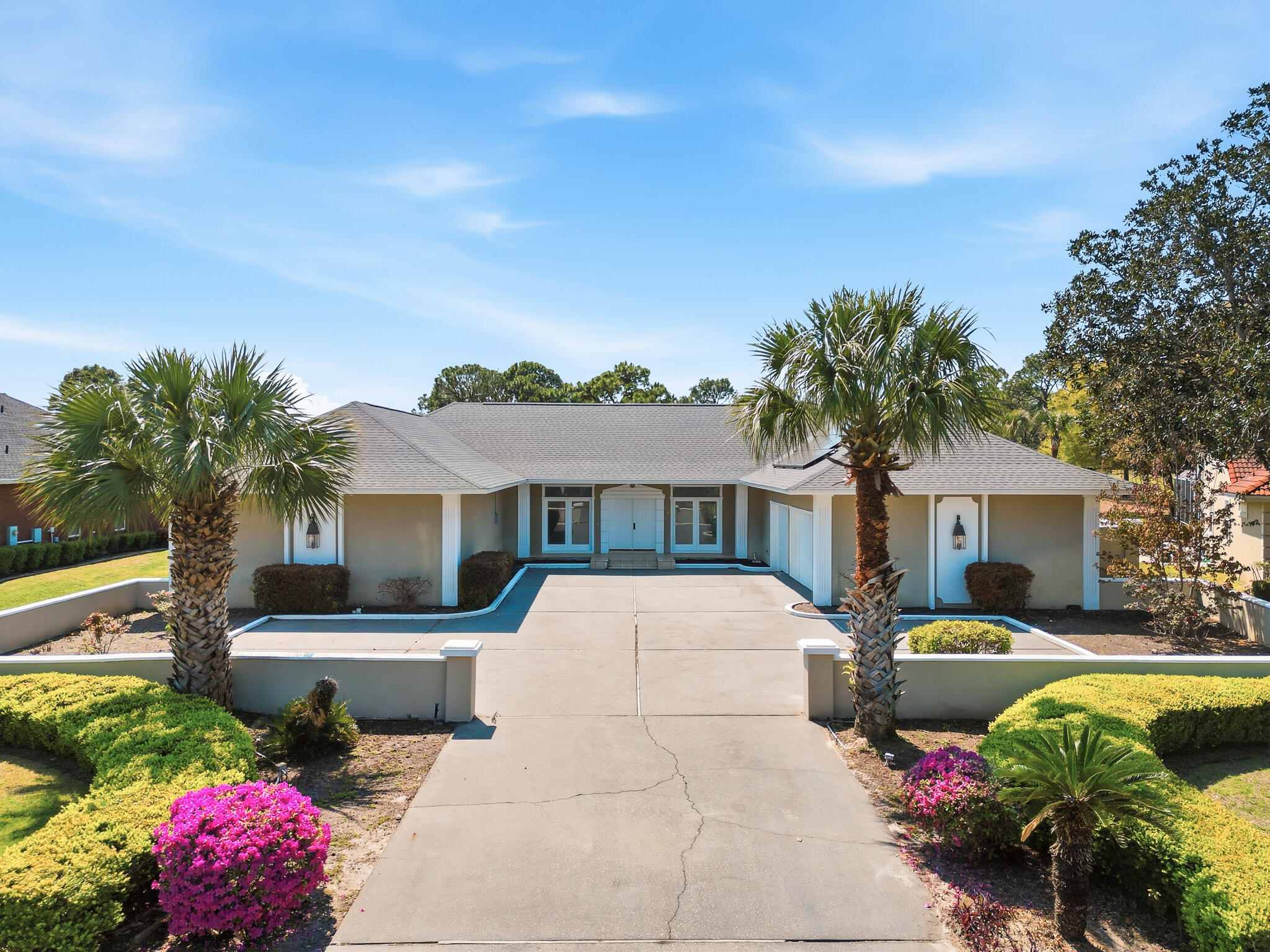 8 Weekewachee Circle Destin, FL 32541 - Photo 2 of 55 a front view of a house with a garden and swimming pool