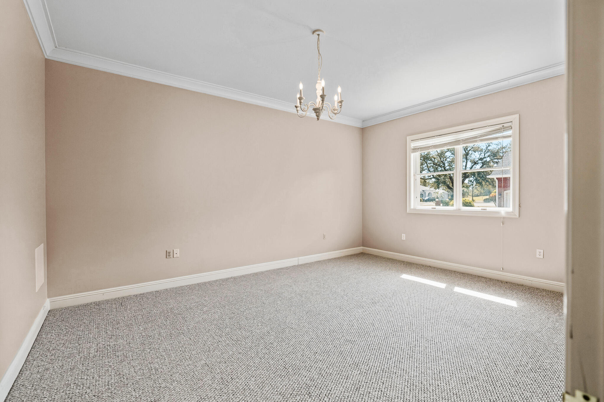 8 Weekewachee Circle Destin, FL 32541 - Photo 35 of 55 an empty room with a chandelier fan and windows