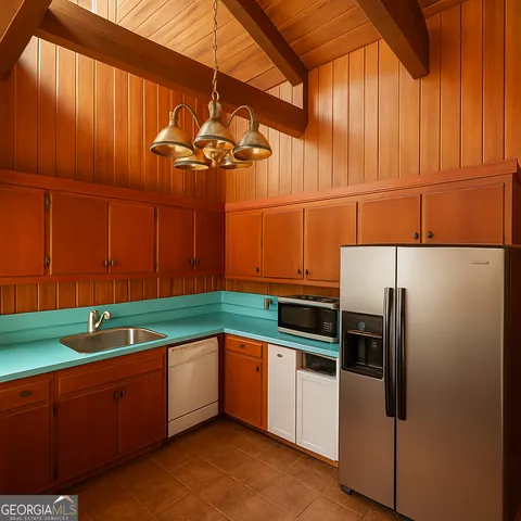 a kitchen with stainless steel appliances granite countertop a sink a stove and a refrigerator