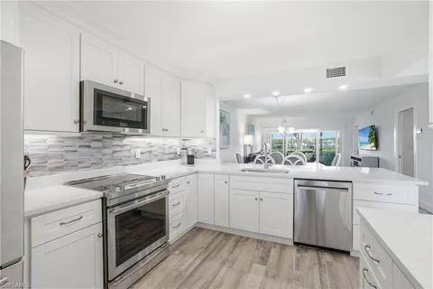 a kitchen with a sink stove and refrigerator