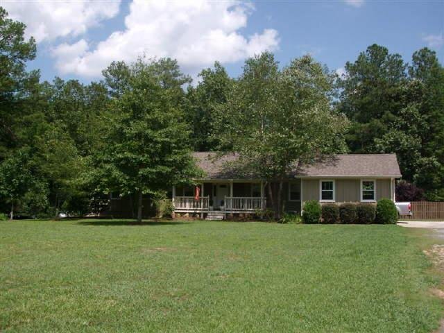 7 McCoy Drive Northeast Rome, GA 30165 - Photo 1 of 1 a front view of a house with a garden and trees