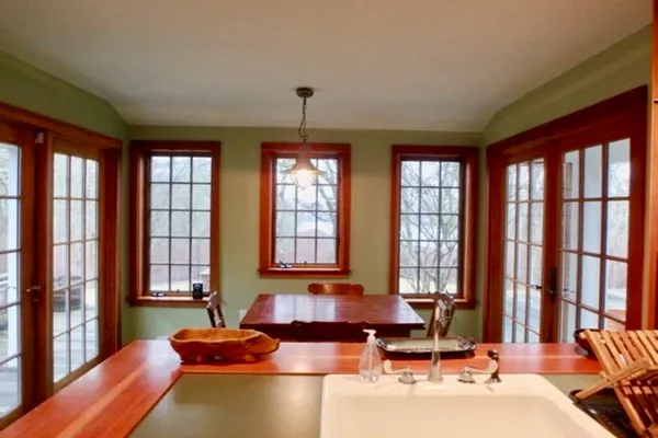 a living room with furniture and floor to ceiling windows