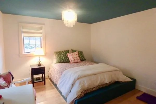 a bedroom with a bed and a lamp on table