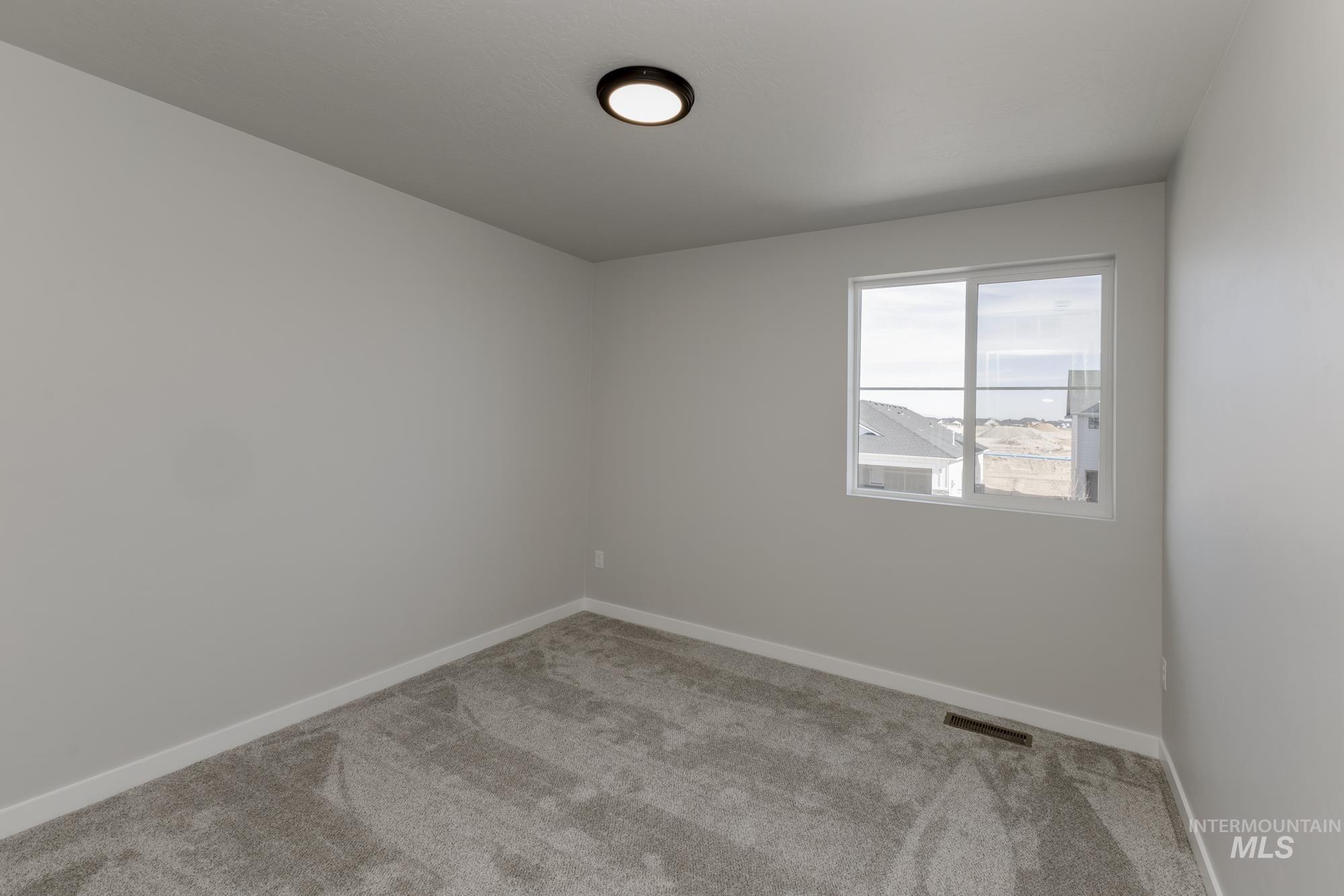 12853 Decatur Street Nampa, ID 83651 - Photo 17 of 24 Neutral gray walls complemented by gray carpet flooring