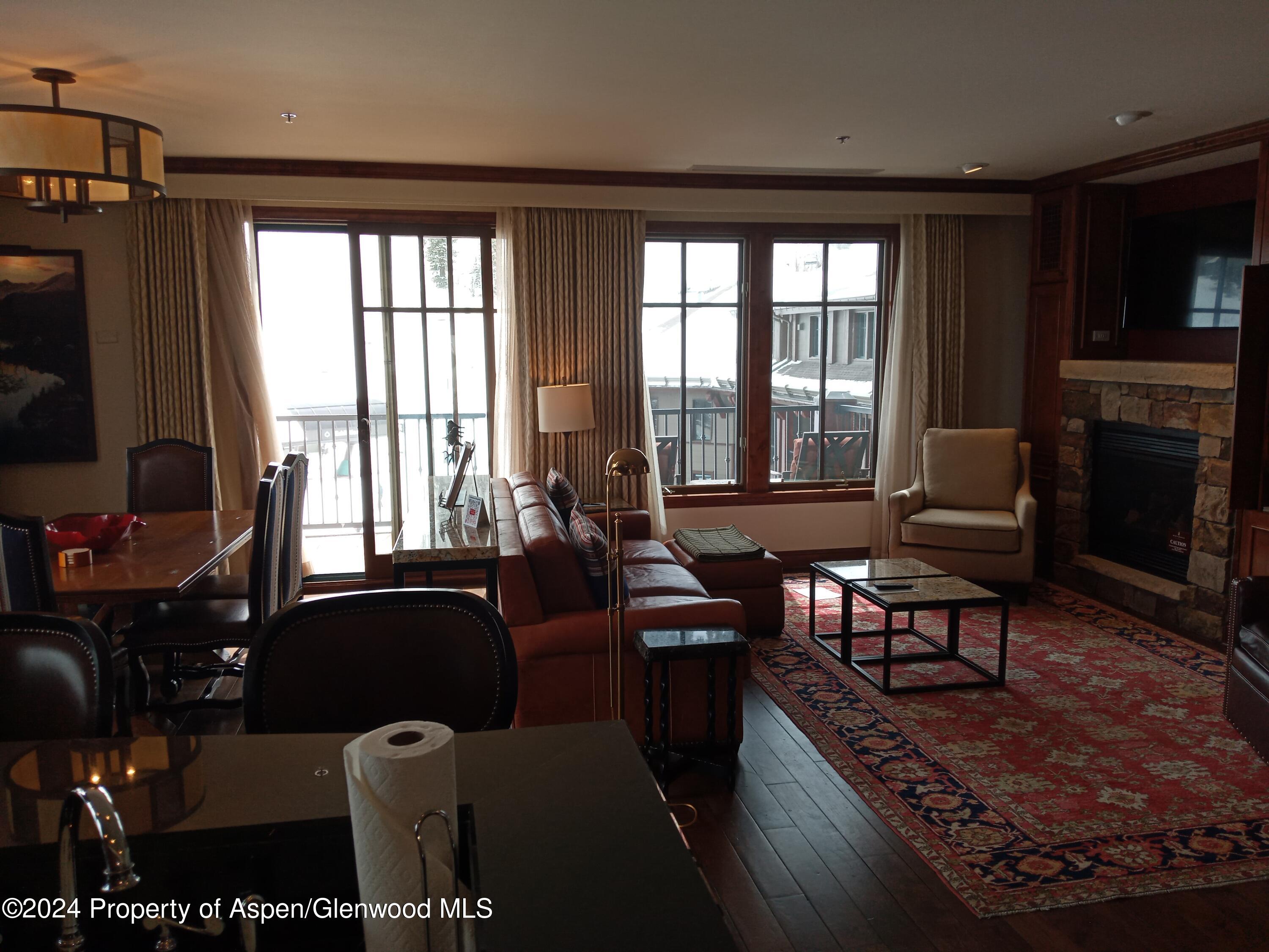 75 Prospector Road, Unit 841012 Aspen, CO 81611 - Photo 39 of 43 a living room with furniture and a flat screen tv
