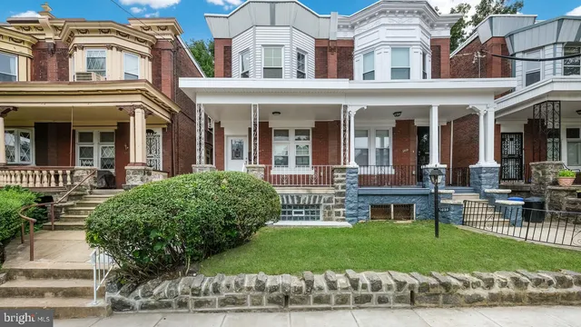 front view of a brick house with a yard