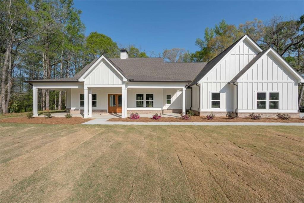 11691 Hazelbrand Road Northeast Covington, GA 30014 - Photo 1 of 53 a front view of a house with swimming pool having outdoor seating