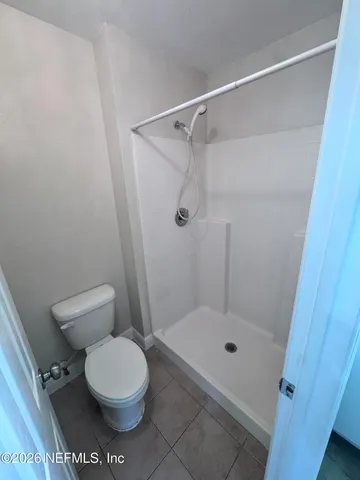 a bathroom with a toilet and a shower