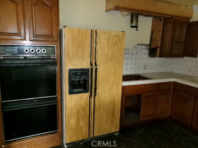 17392 Cache Creek Road Clearlake Oaks, CA 95423 - Photo 11 of 25 a kitchen with stainless steel appliances a refrigerator and a sink