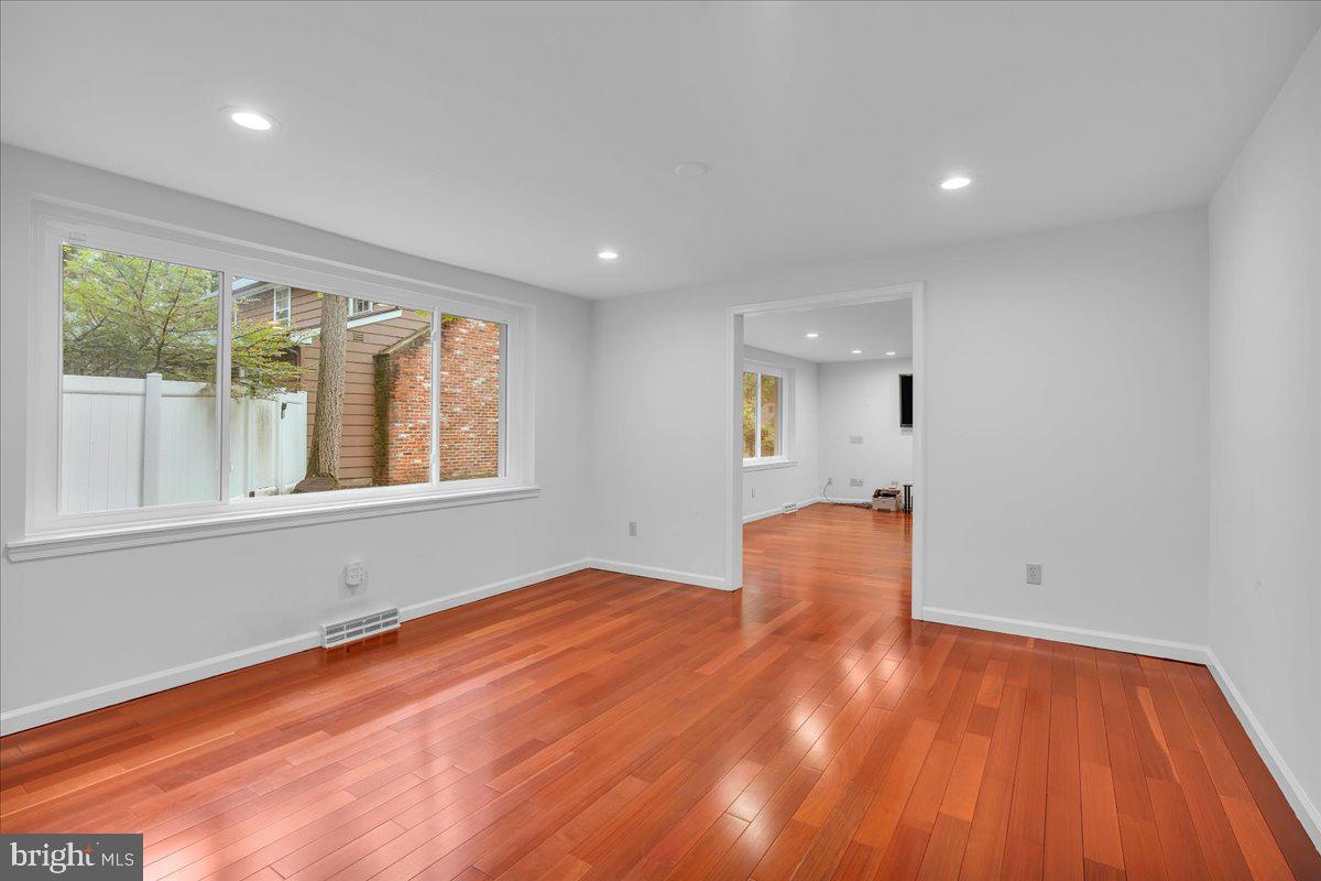 114 Partree Road Cherry Hill, NJ 08003 - Photo 11 of 44 an empty room with wooden floor and windows