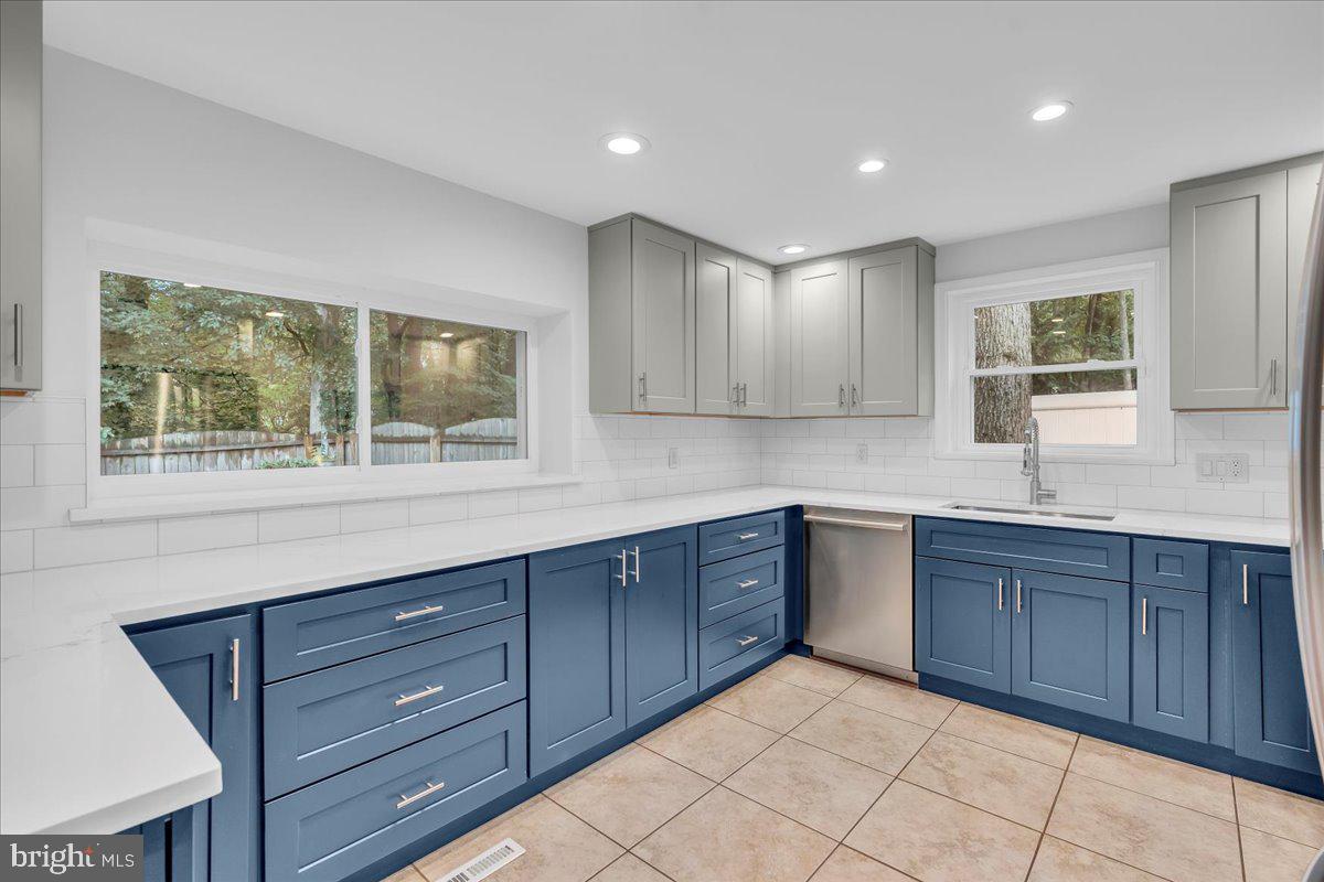 114 Partree Road Cherry Hill, NJ 08003 - Photo 16 of 44 a kitchen with wooden cabinets and a sink