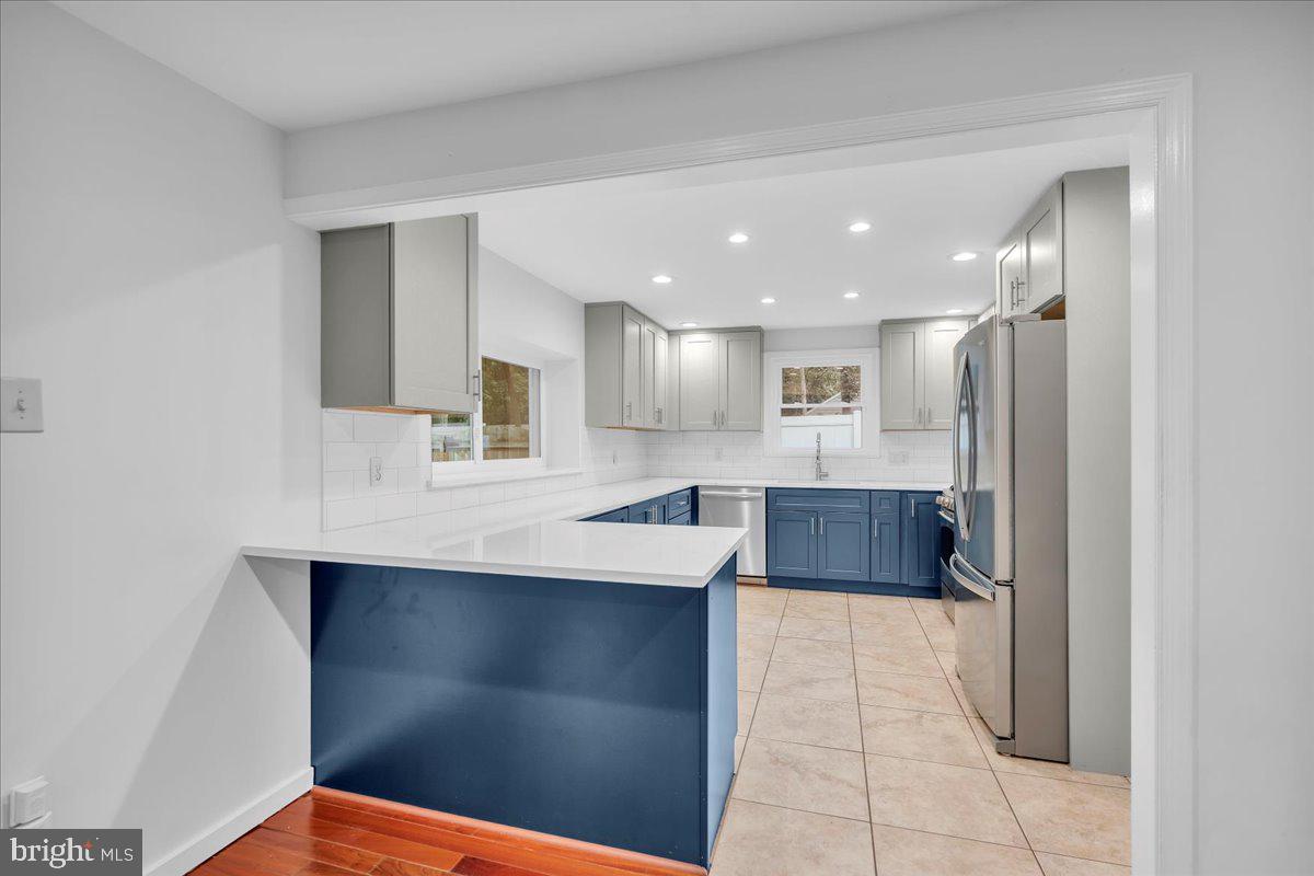 114 Partree Road Cherry Hill, NJ 08003 - Photo 17 of 44 a large kitchen with stainless steel appliances kitchen island granite countertop a refrigerator and a sink