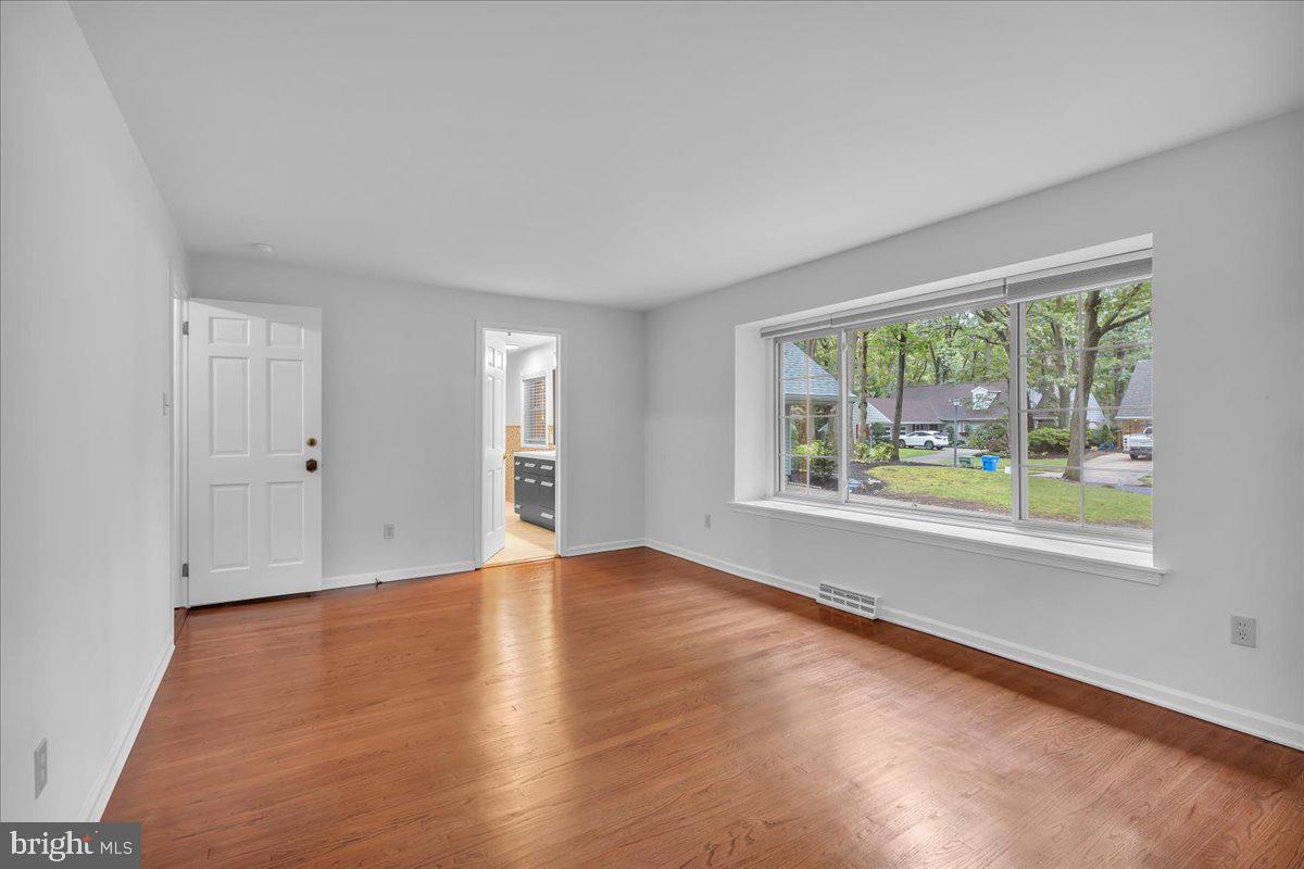 114 Partree Road Cherry Hill, NJ 08003 - Photo 18 of 44 a view of an empty room with wooden floor and a window