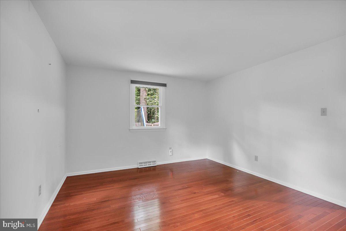 114 Partree Road Cherry Hill, NJ 08003 - Photo 23 of 44 an empty room with wooden floor and windows