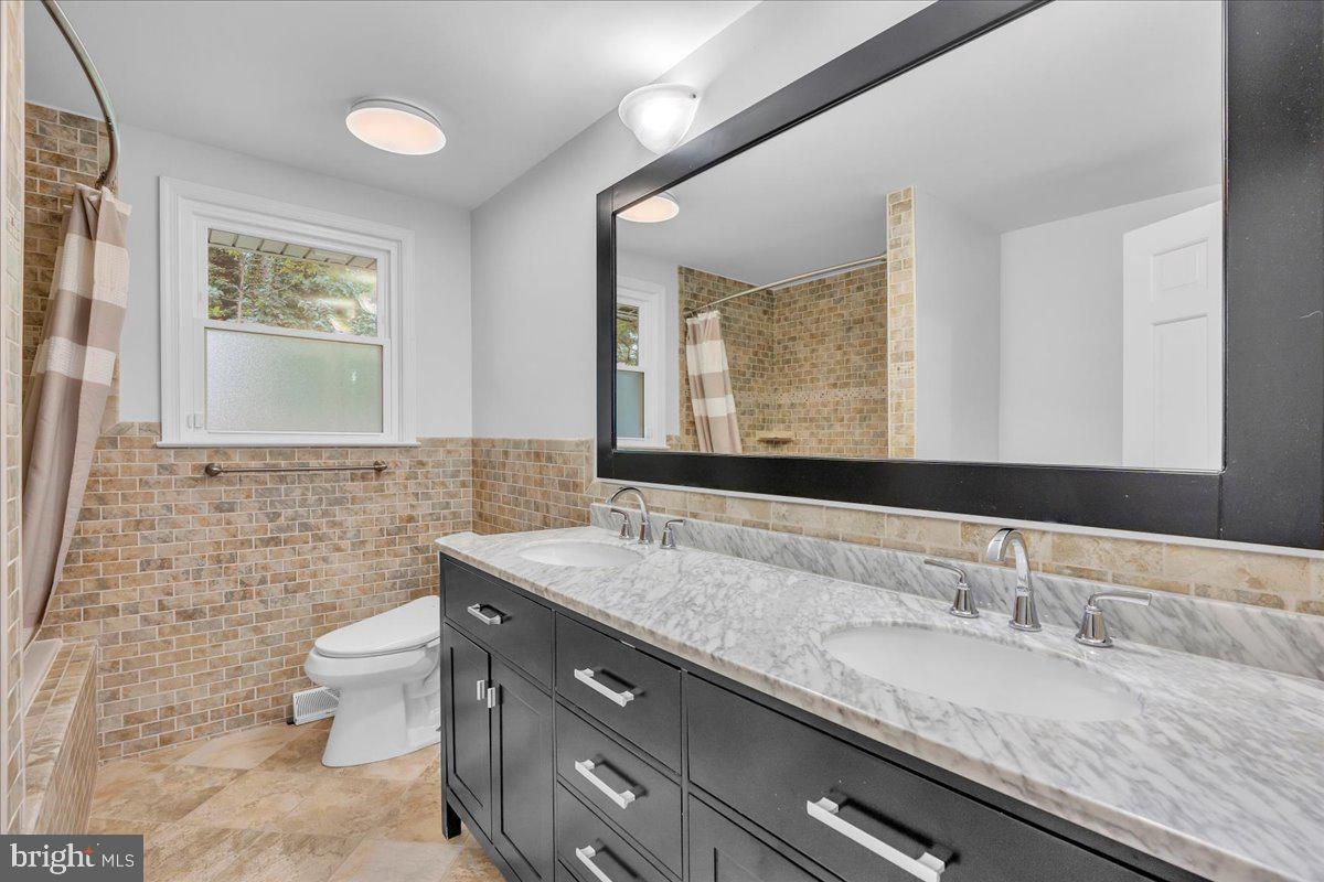 114 Partree Road Cherry Hill, NJ 08003 - Photo 25 of 44 a bathroom with a granite countertop sink a toilet and mirror