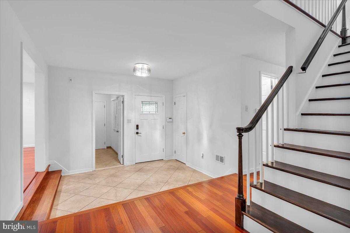 114 Partree Road Cherry Hill, NJ 08003 - Photo 8 of 44 a view of an empty room with wooden floor and stairs
