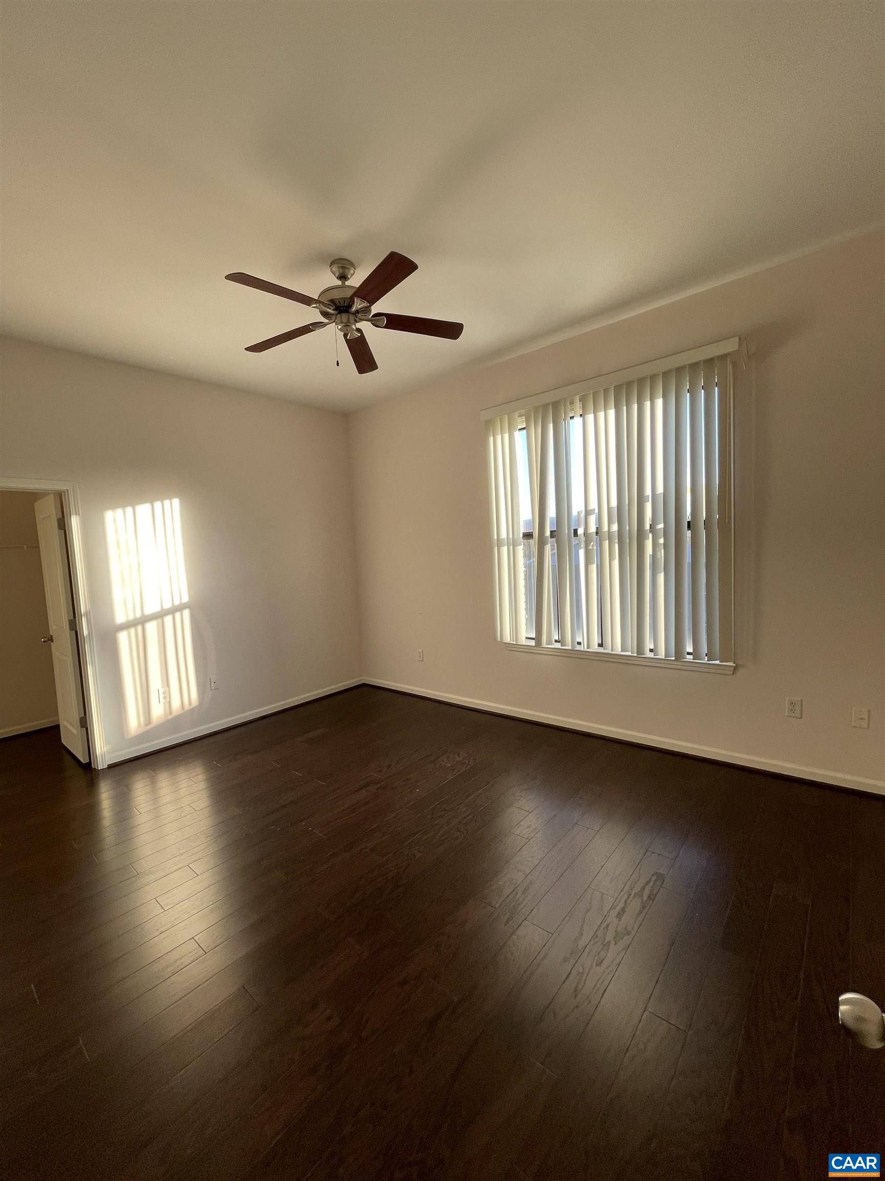 735 Walker Square, Unit 4A Charlottesville, VA 22903 - Photo 4 of 7 a view of an empty room with wooden floor and a window