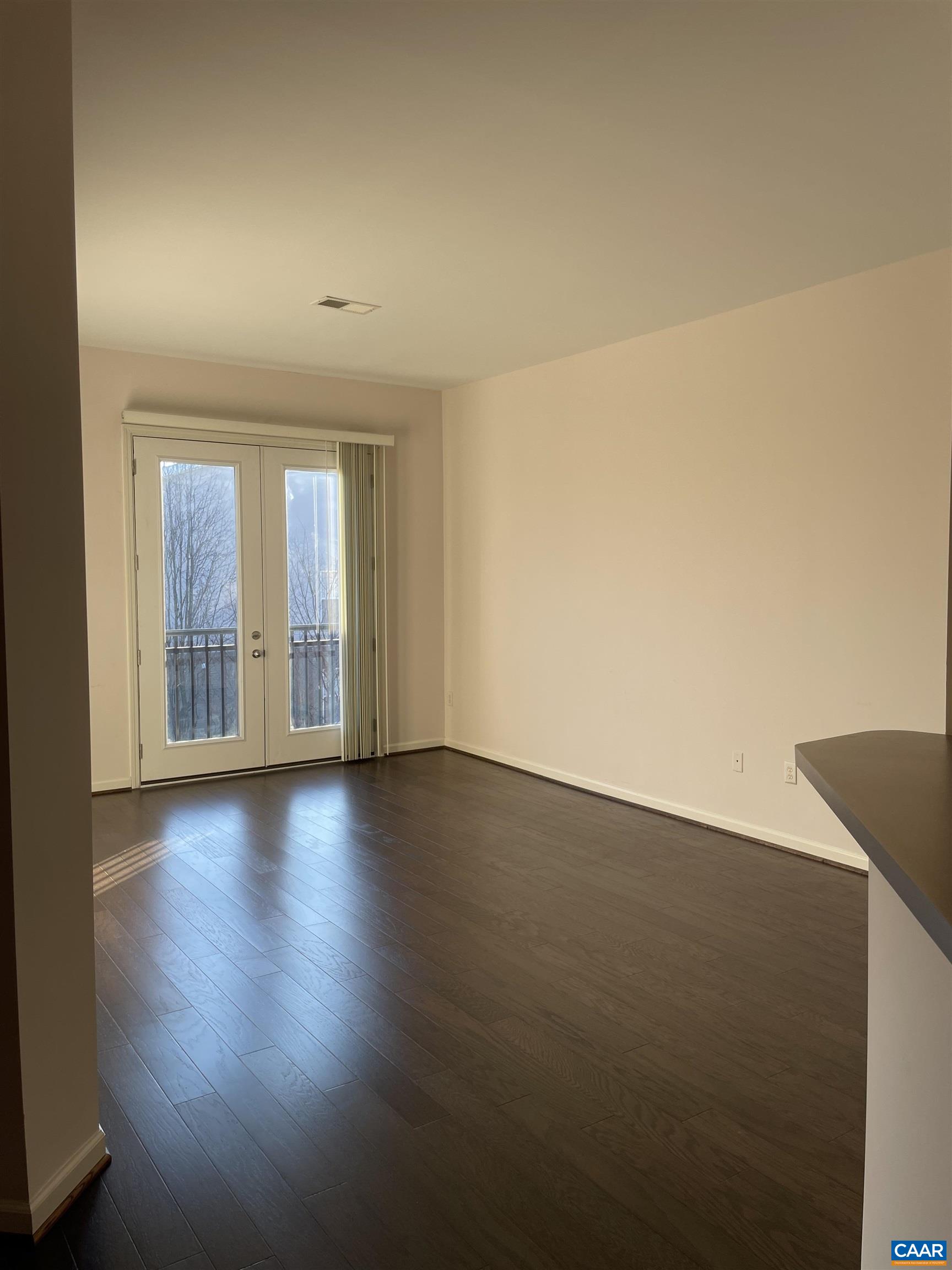 735 Walker Square, Unit 4A Charlottesville, VA 22903 - Photo 6 of 7 an empty room with wooden floor and windows