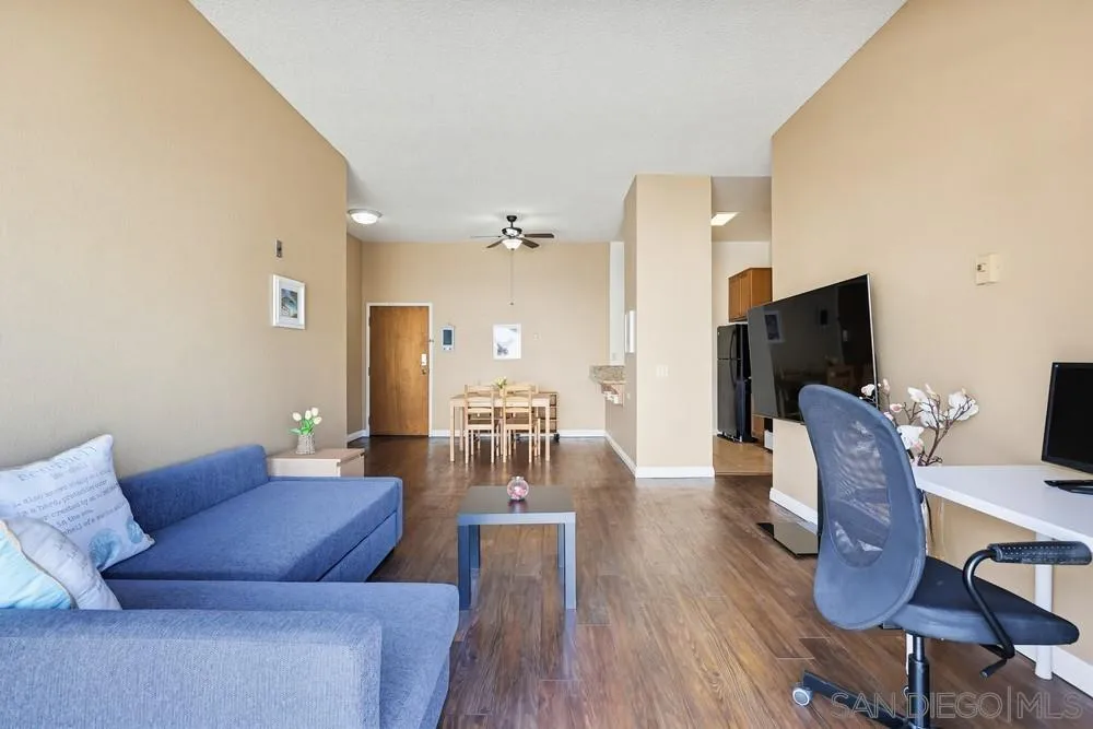 8324 Regents Road, Unit 2E San Diego, CA 92122 - Photo 15 of 31 a living room with furniture wooden floor and a flat screen tv