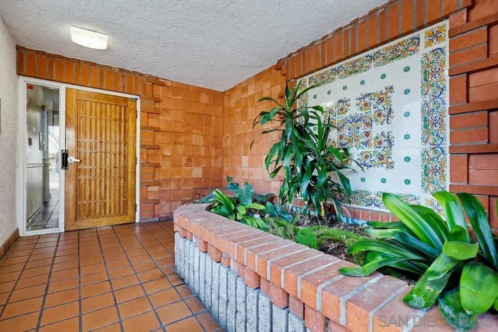 8324 Regents Road, Unit 2E San Diego, CA 92122 - Photo 3 of 31 a porch with potted plants in front of door