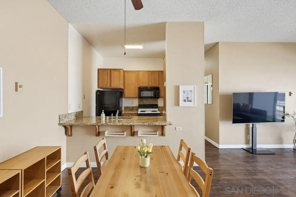 8324 Regents Road, Unit 2E San Diego, CA 92122 - Photo 8 of 31 a living room with furniture and a flat screen tv