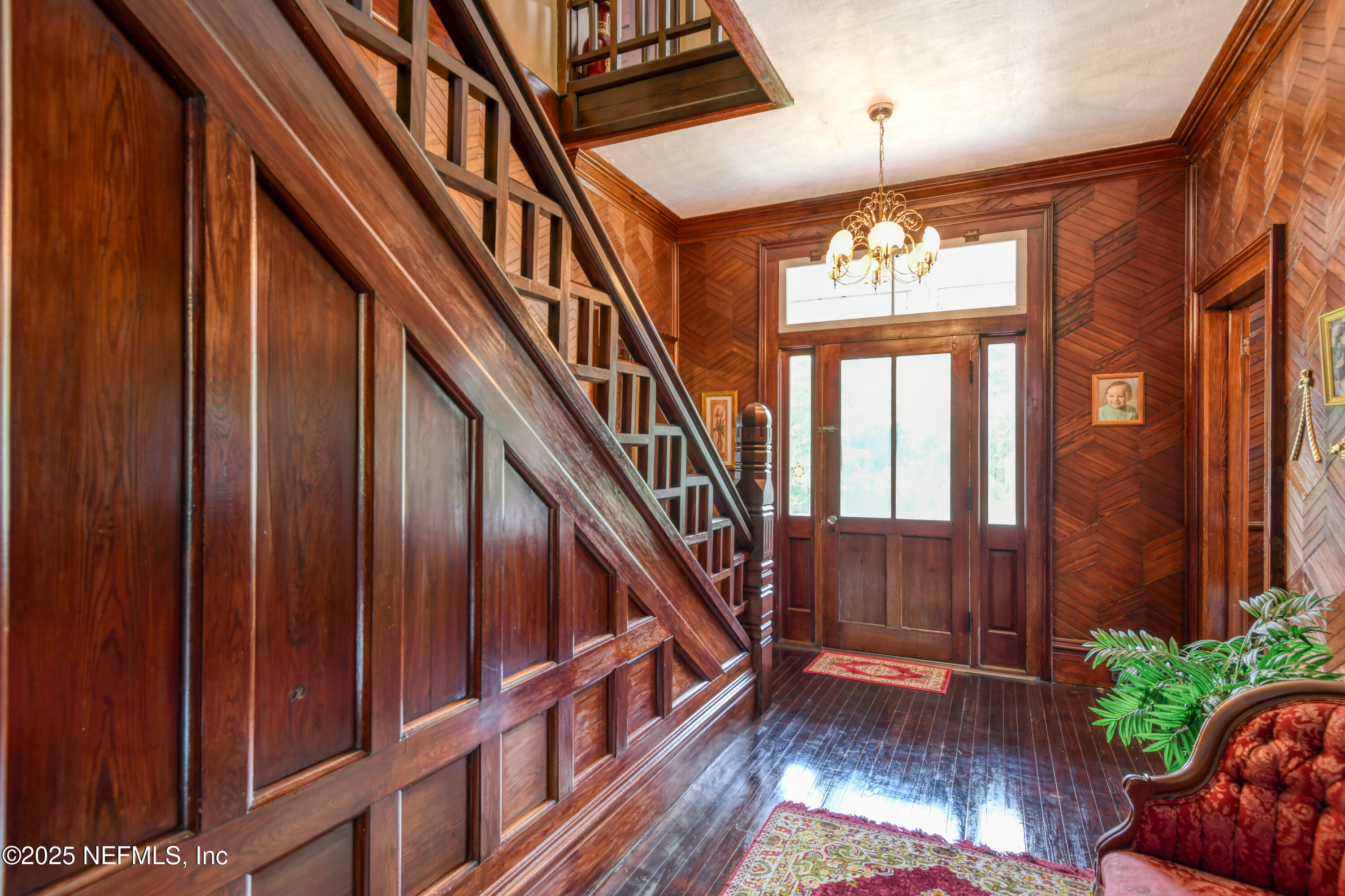 240 Sisco Road Pomona Park, FL 32181 - Photo 13 of 43 a view of an entryway wooden floor and chandelier